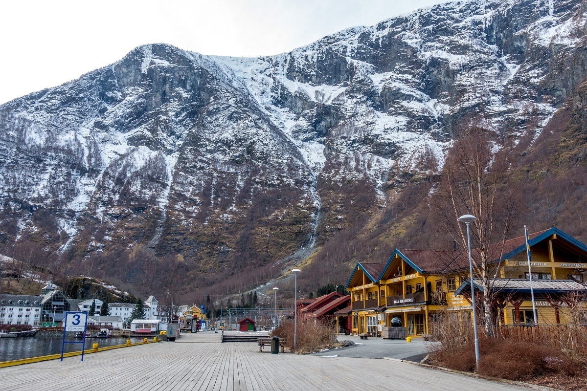 Buildings in the village of Flam Norway set against a snowy mountain