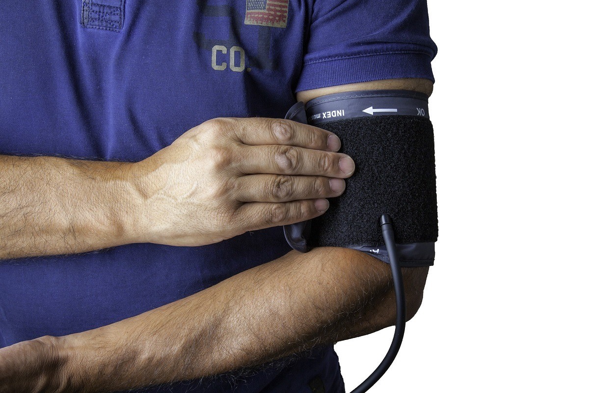 Man putting on blood pressure cuff