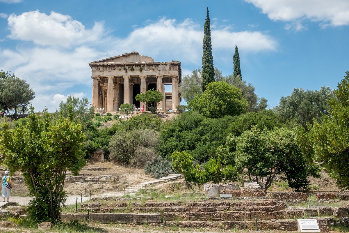 Well-preserved ancient temple with columns surrounded by trees--the Temple of Hephaestus