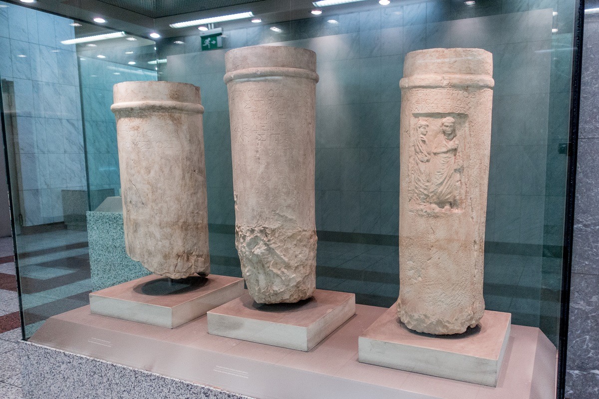 Ancient pillars displayed behind glass in the metro in Athens, Greece