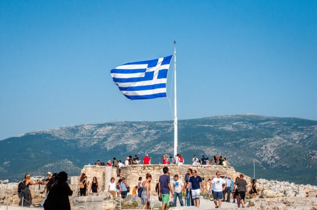The Highlights and More: How to Spend 3 Days in Athens, Greece Flag on top of the Acropolis in Athens, Greece