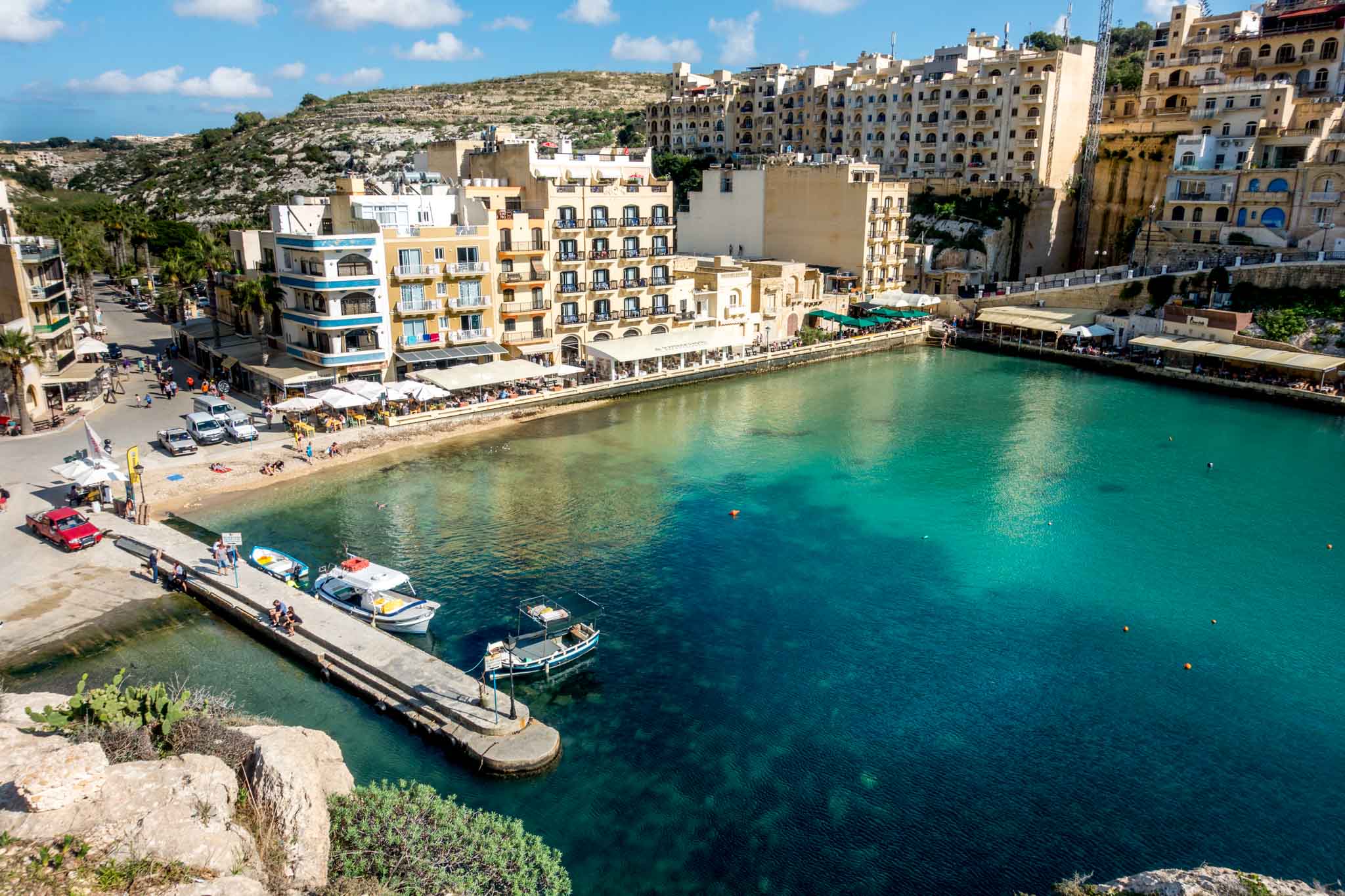 Bay surrounded by buildings in Xlendi, Malta