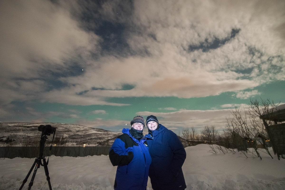 Use a short burst from a flashlight to take a northern lights selfie. It's cold so clothing in Norway can be heavy! This isn't the place to make a fashion statement.