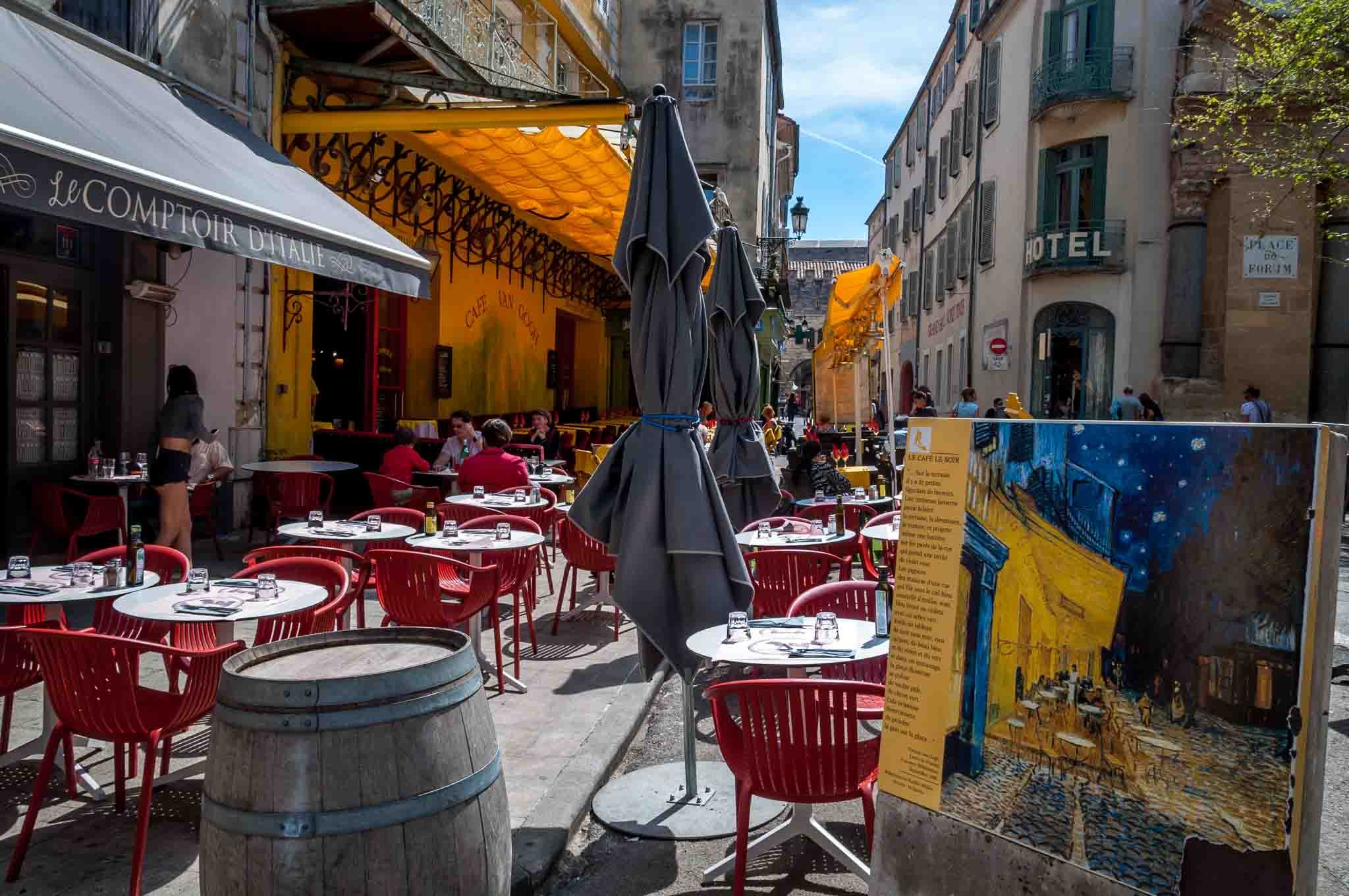Modern-day sidewalk cafe alongside the painting van Gogh made of the site in the 1800s