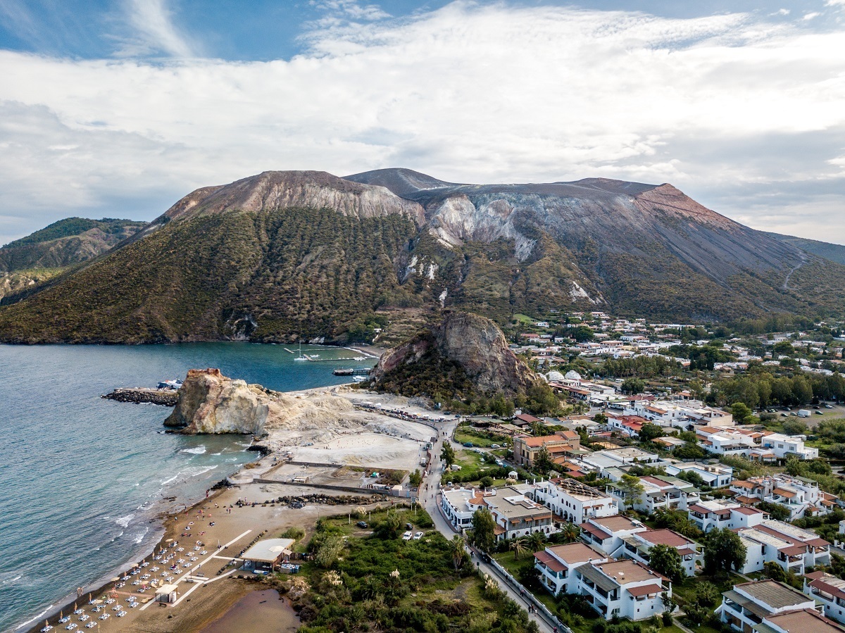 One of the top things to do on Vulcano Island is hiking the Grand Cratere above the town of Porto di Levante. (Aerial photo from drone of Vulcano Italy)