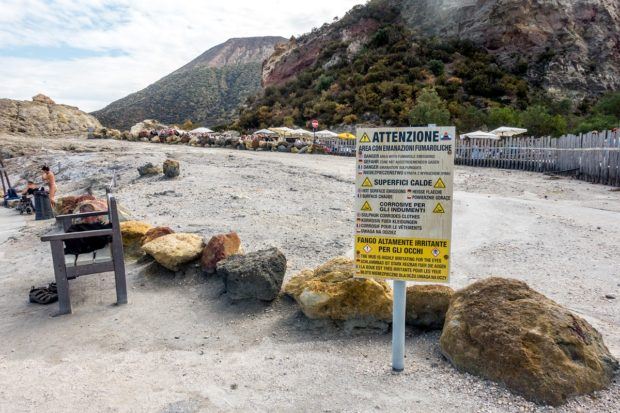Advisory notices are prominently placed around the mud baths on Vulcano Island (Laghetto di Fanghi).