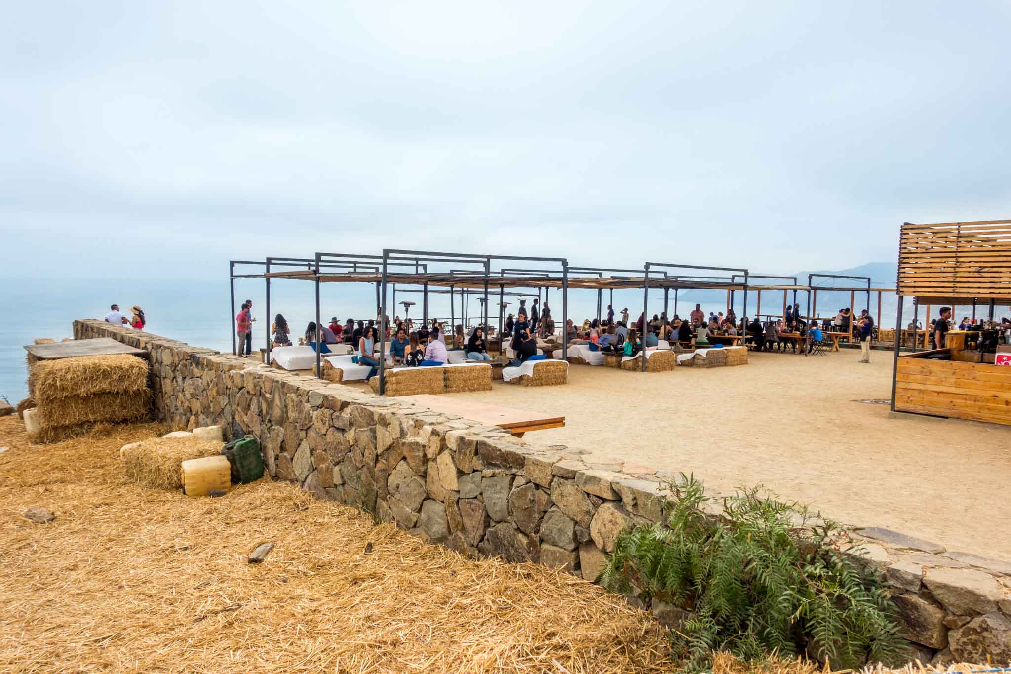 People enjoying views of the Pacific Ocean from Bar Bura at Cuatro Cuatros