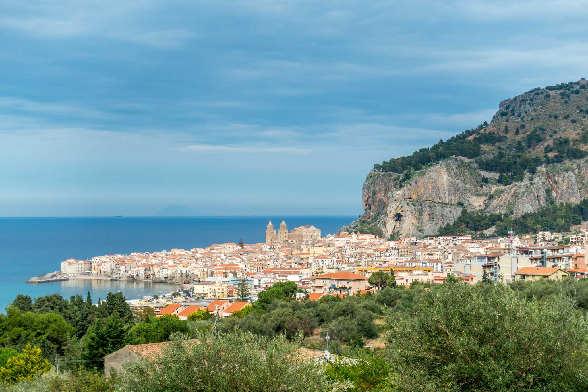 Buildings of Cefalu between the ocean and a monolith rock