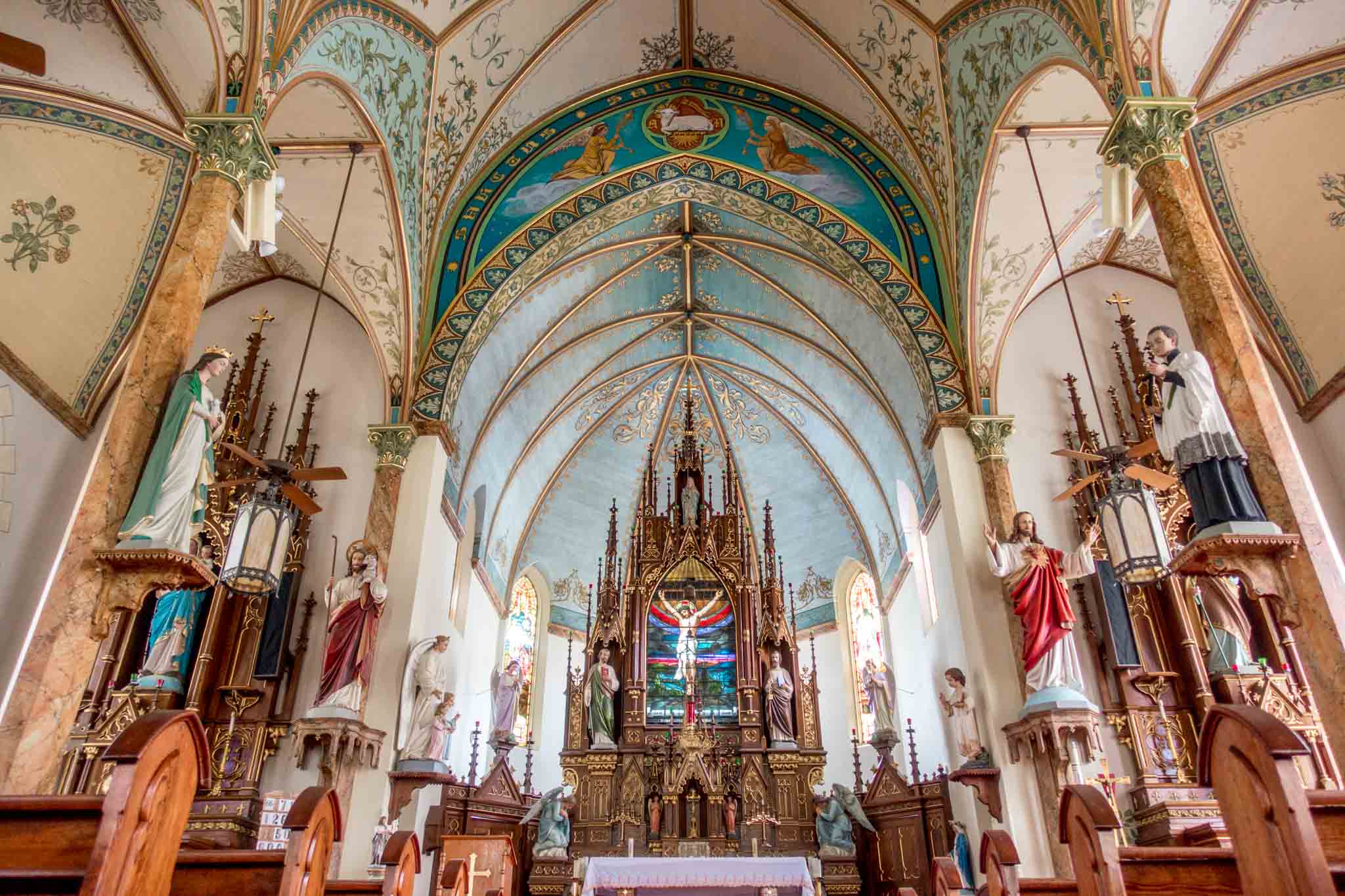 Statues and decorative ceiling in a church sanctuary