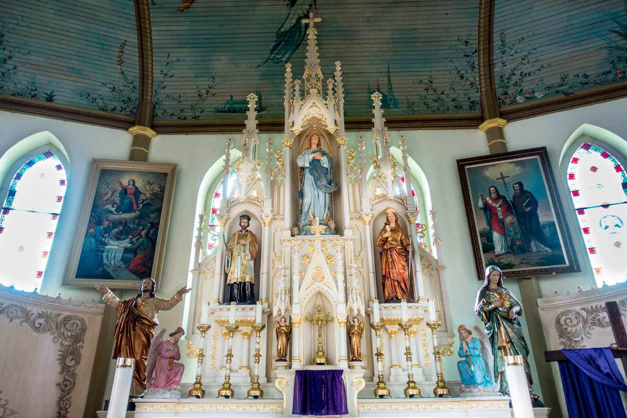 Altar, statues, and turquoise ceiling in church