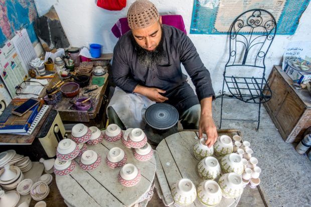 A Morocco travel guide can guide you toward unique experiences like watching pottery making in Fez