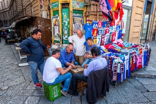 Men playing cards at Vuccaria market in Palermo Italy