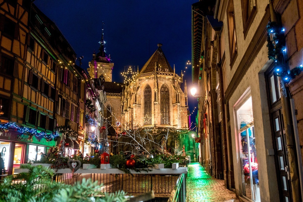 Church and buildings in Colmar, France, lit up for the holiday season