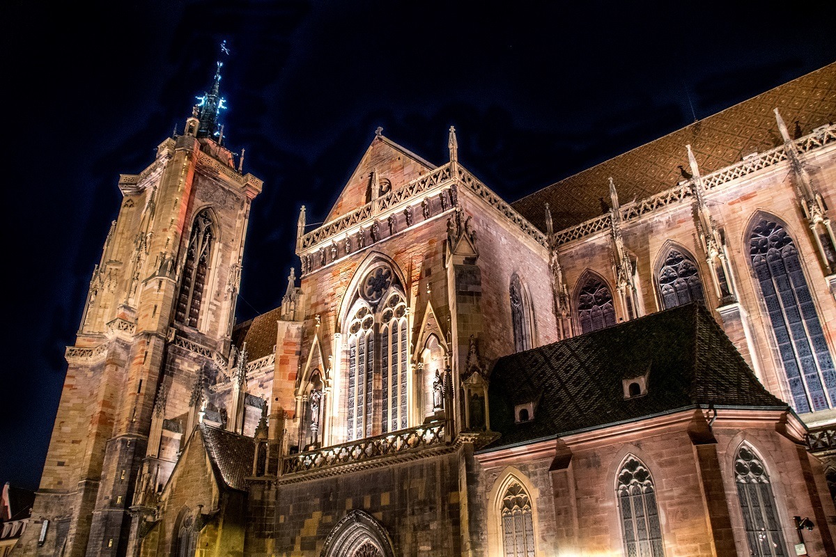 The Collegiate Church of St. Martin in Colmar, France, lit up at night