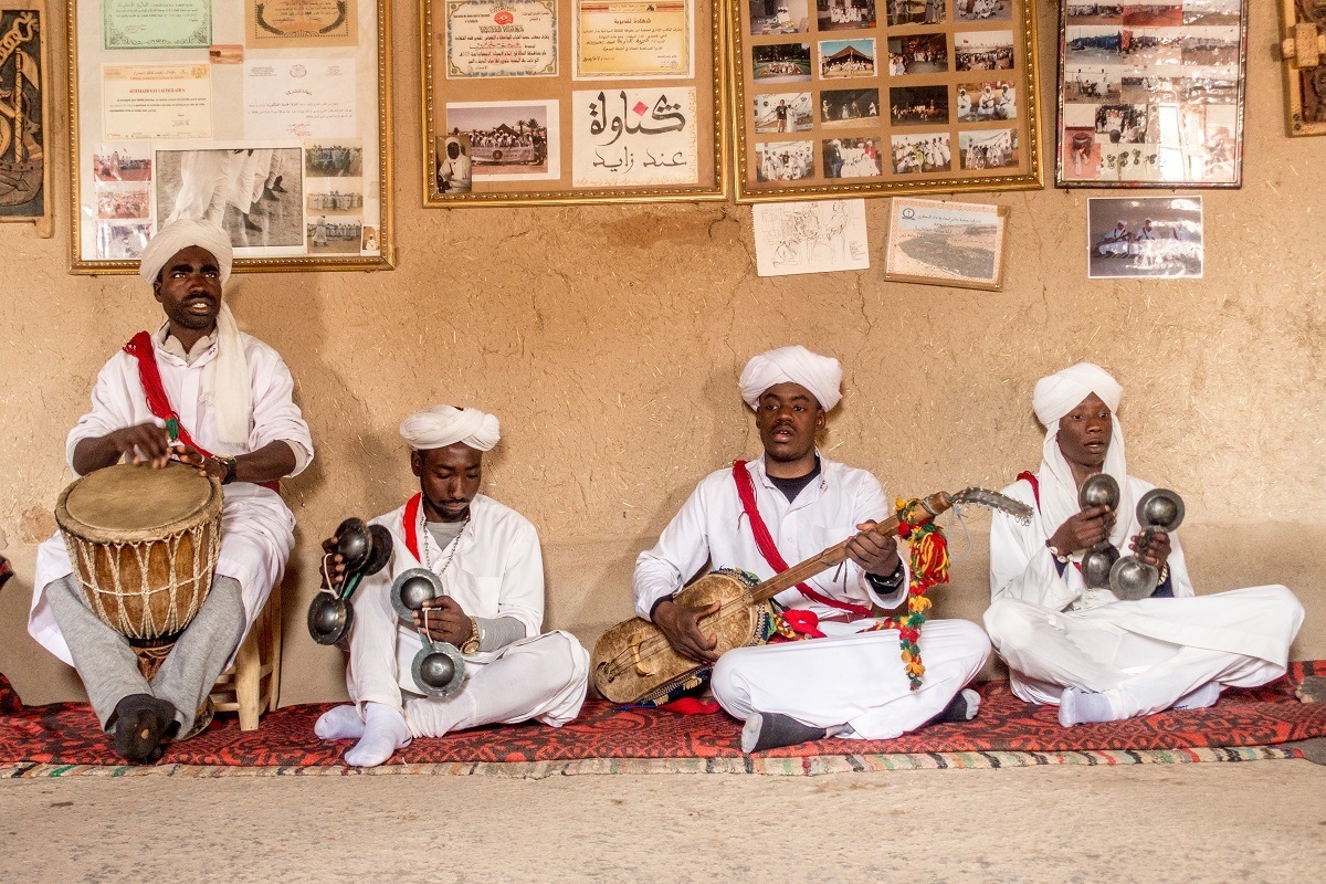 Seated Gnawa musicians performing near Merzouga, Morocco