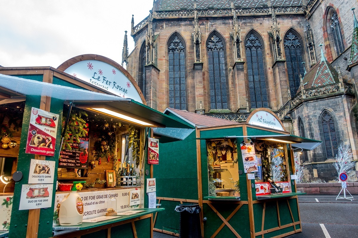 Gourmet food market vendors by cathedral in Colmar
