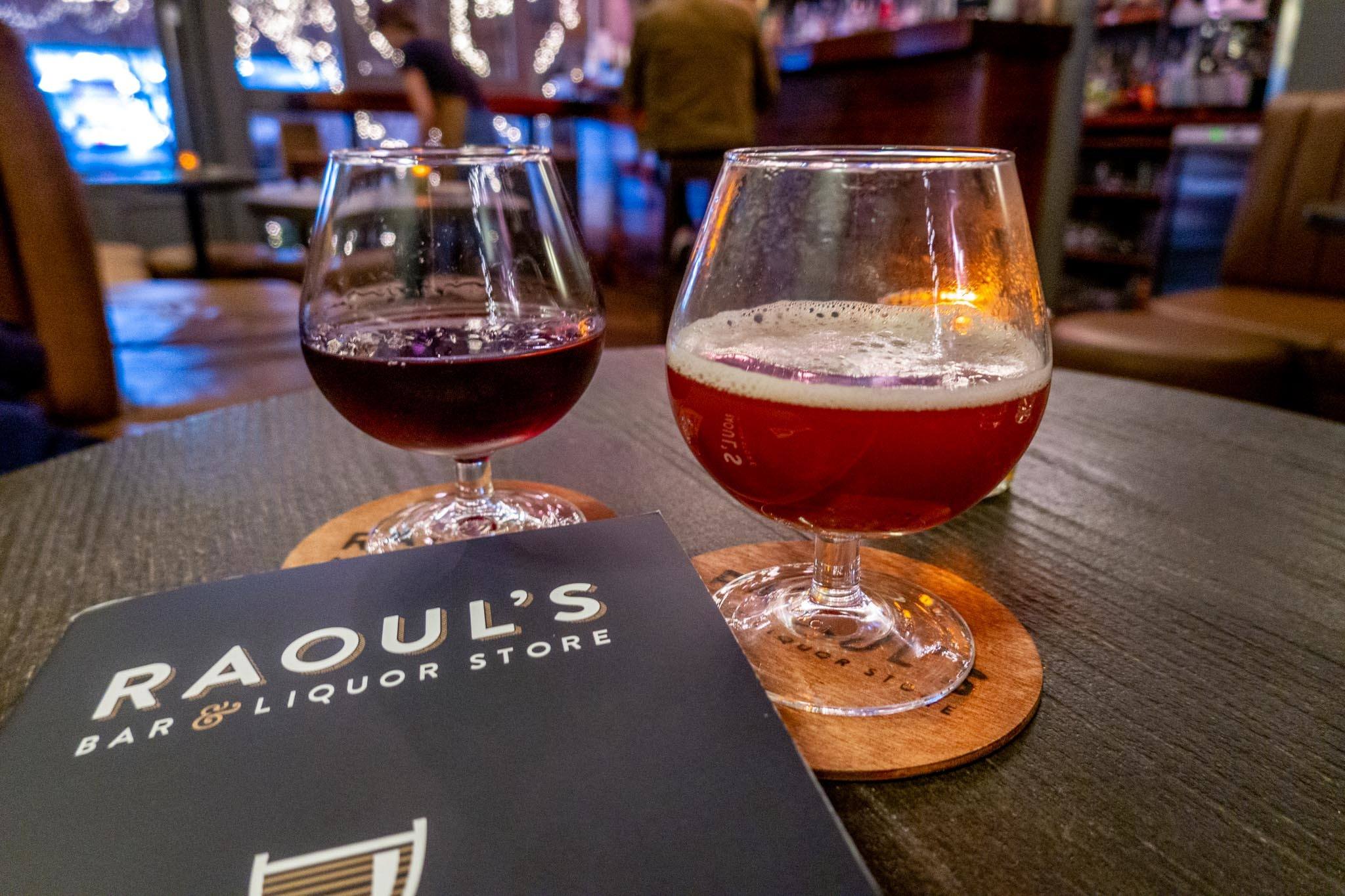 Two cocktails on a table with a menu from Raoul's bar in Oxford, England