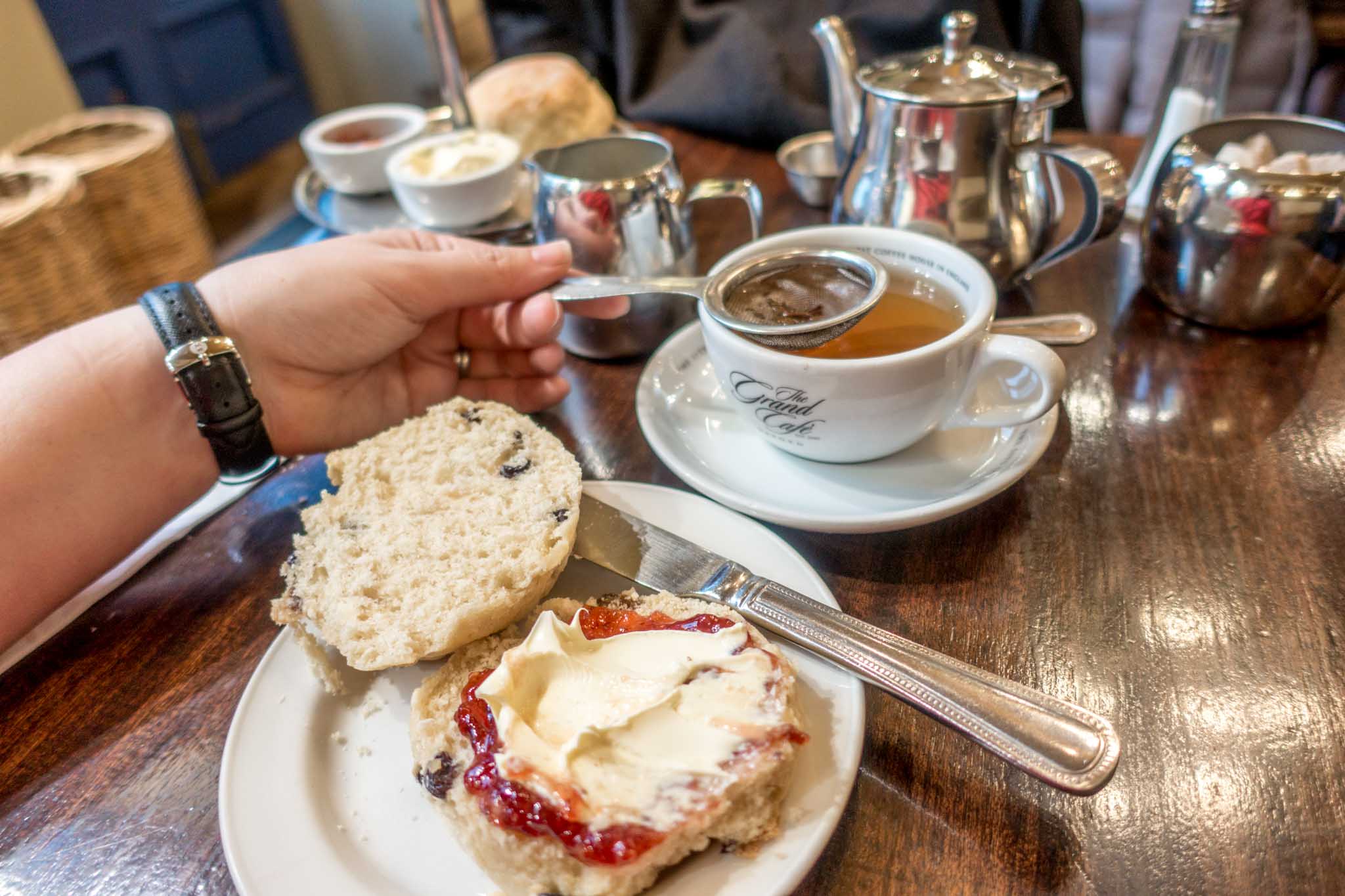 Scone and cup of tea on a table at the Grand Cafe in Oxford UK