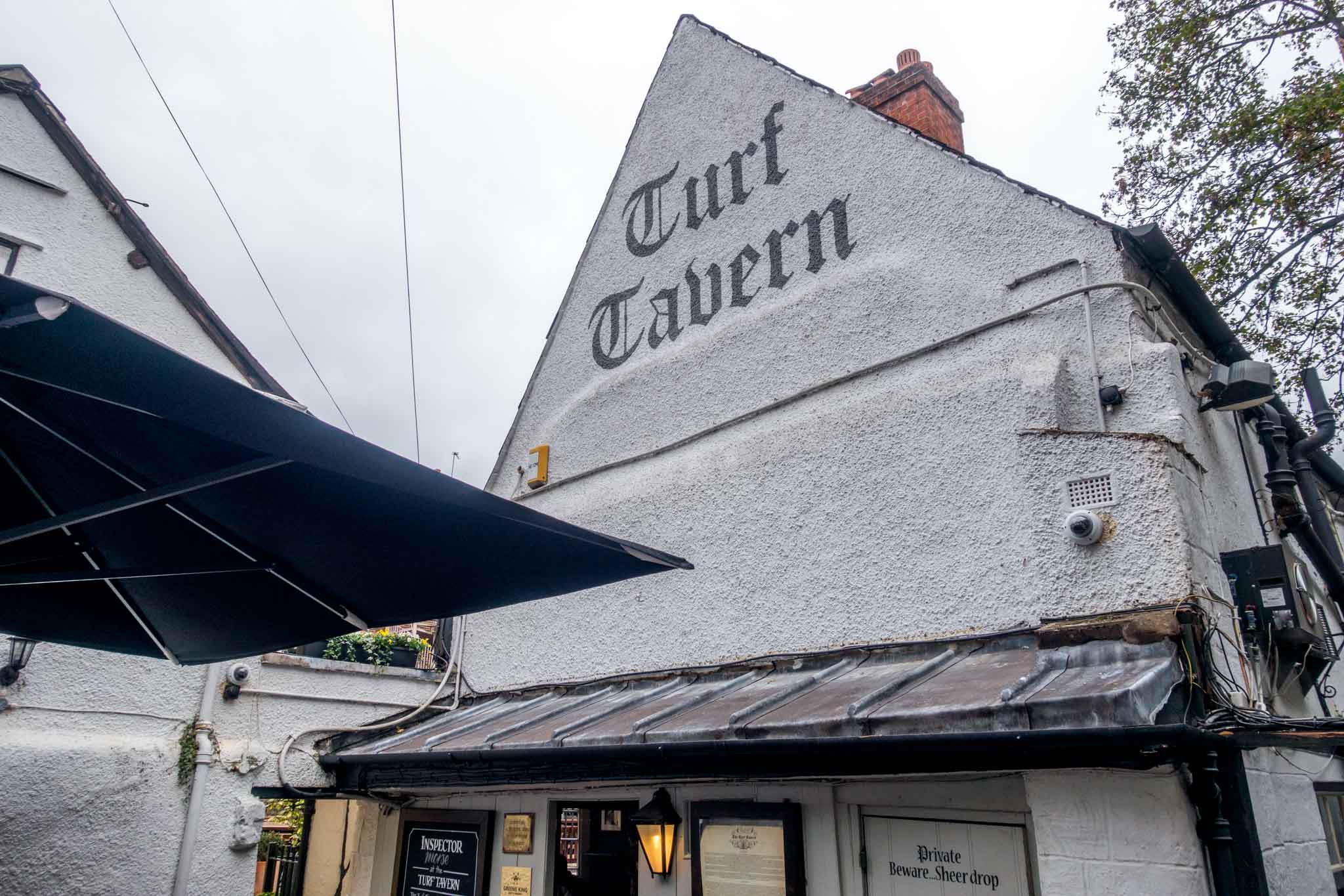 White exterior and sign at the historic Turf Tavern