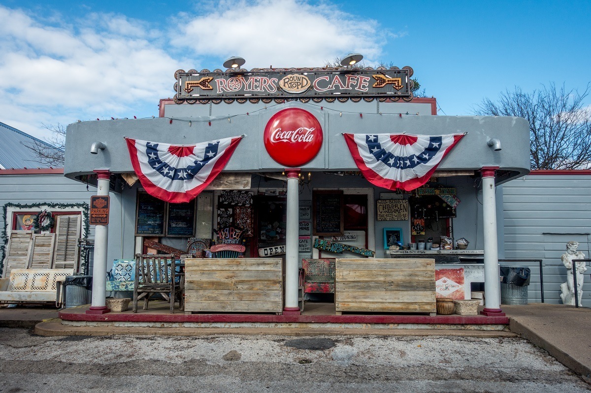 Gray exterior of Royers Round Top Cafe, one of the popular places to travel in Texas