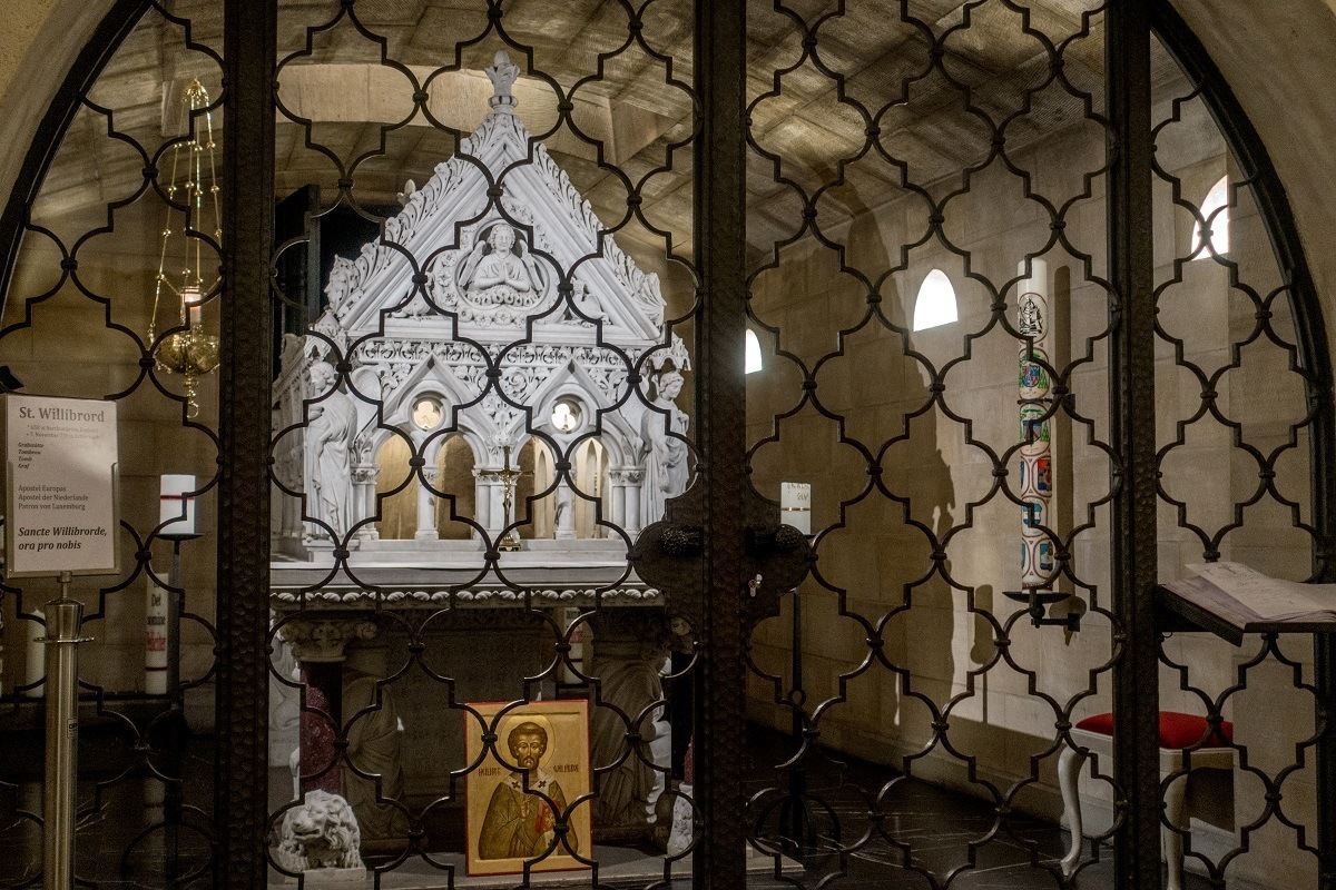 White tomb of St. Willibrord behind a gate