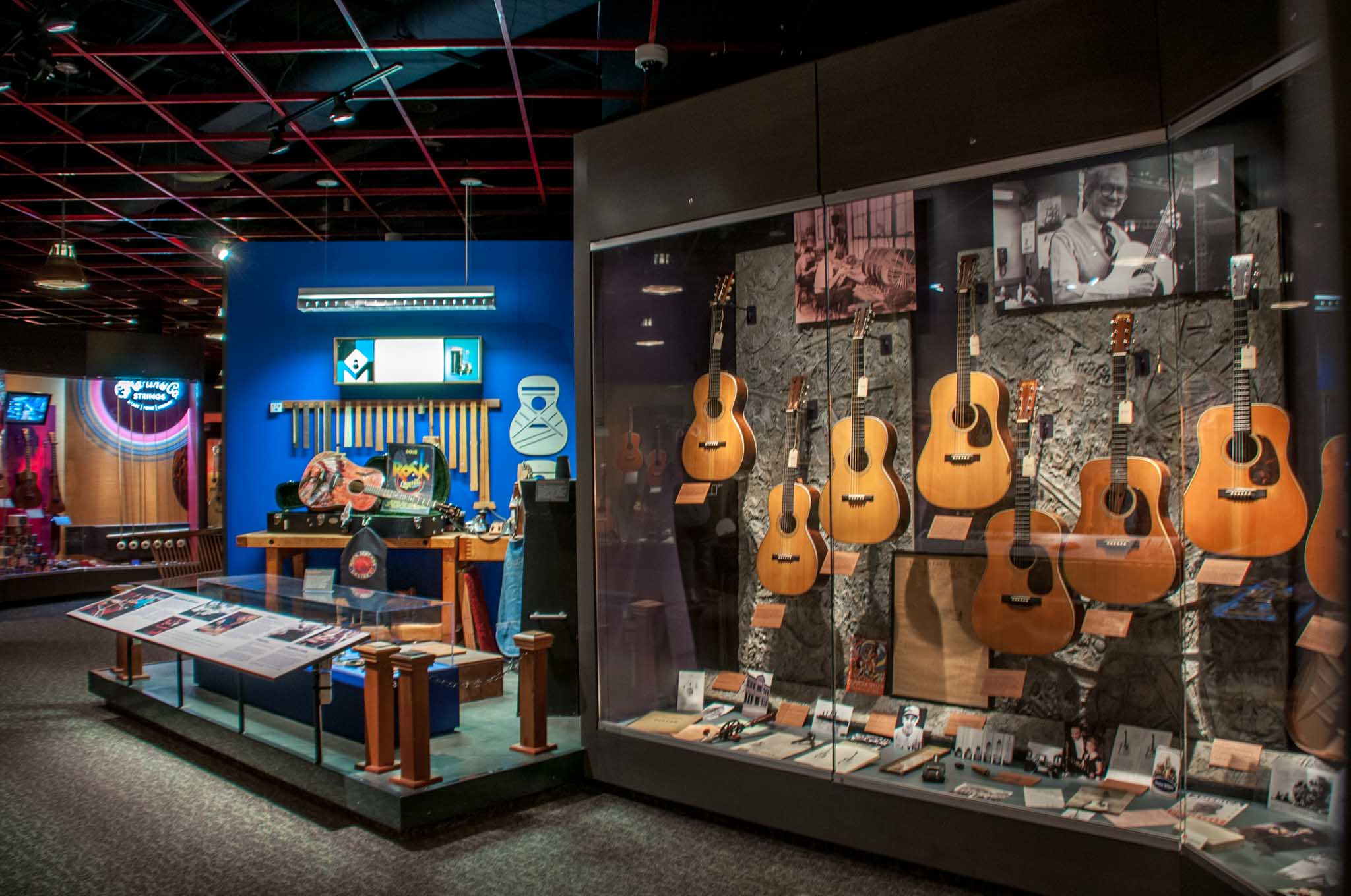 Glass case of guitars in the memorabilia room at the Martin Guitar Factory