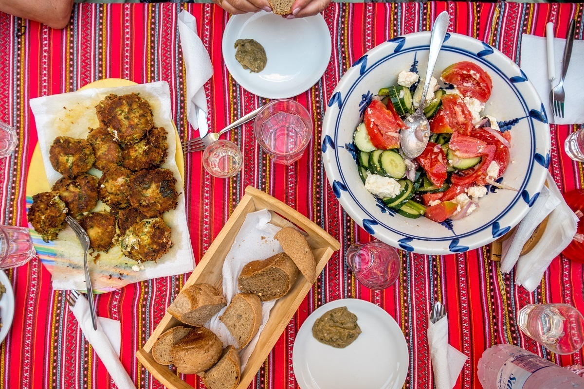 Fresh vegetables and zucchini fritters on a tablecloth