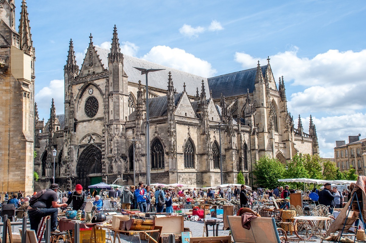 Flea market vendors at the Marche Royal outside a church
