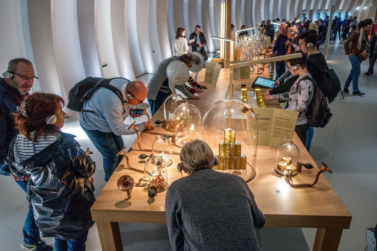 Visitors smelling wine aromas at La Cite du Vin, Bordeaux's wine museum