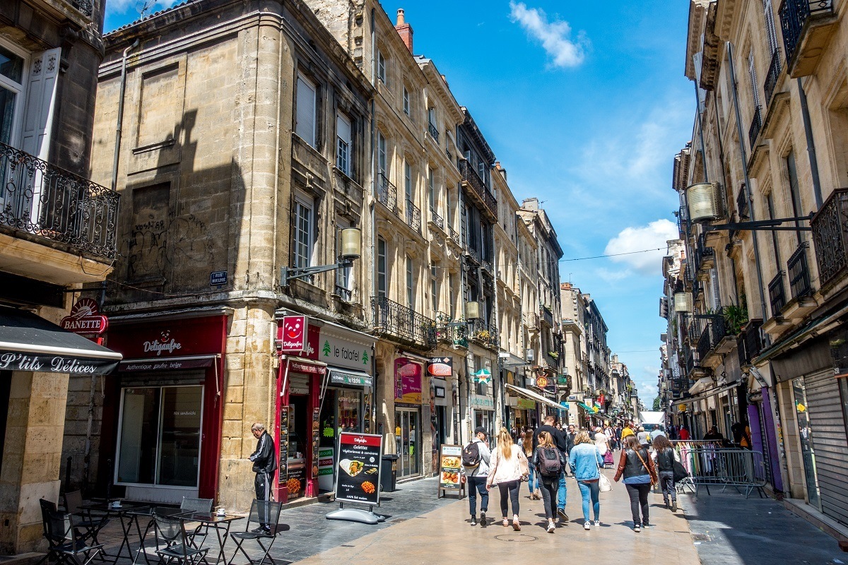 People walking down Rue Sainte-Catherine, a street lined with shops and cafes