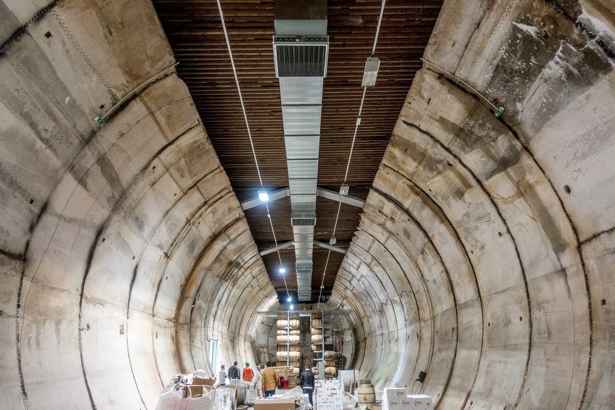 Cylindrical concrete room, filled with whiskey barrels from Moon Harbour Distillery