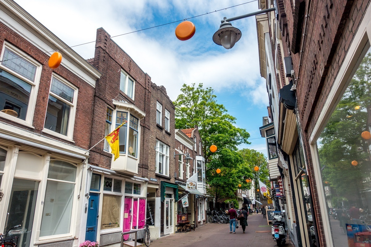 Fake cheese wheels hanging above street