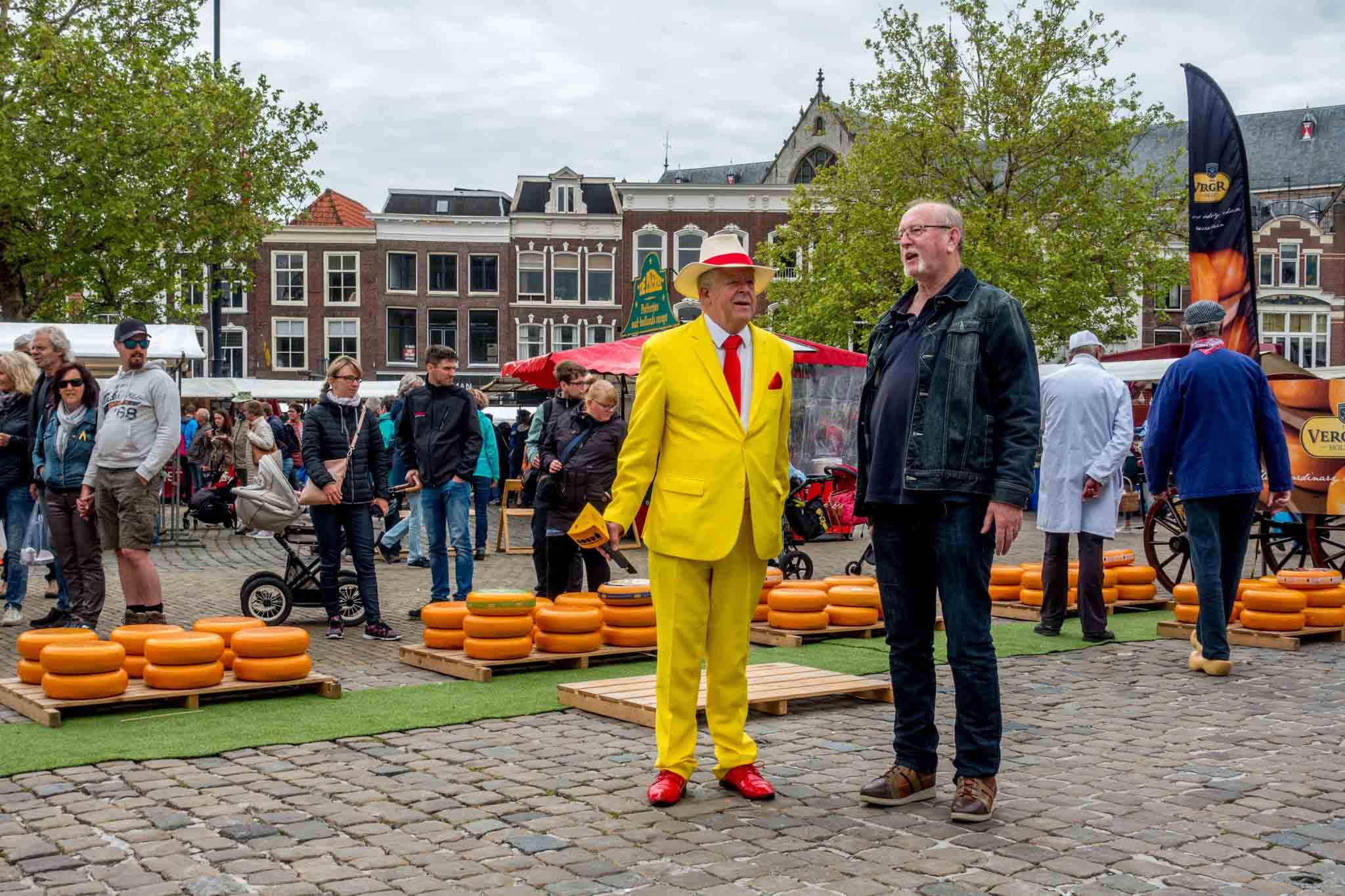 Man in yellow suit narrates the Dutch Gouda cheese market