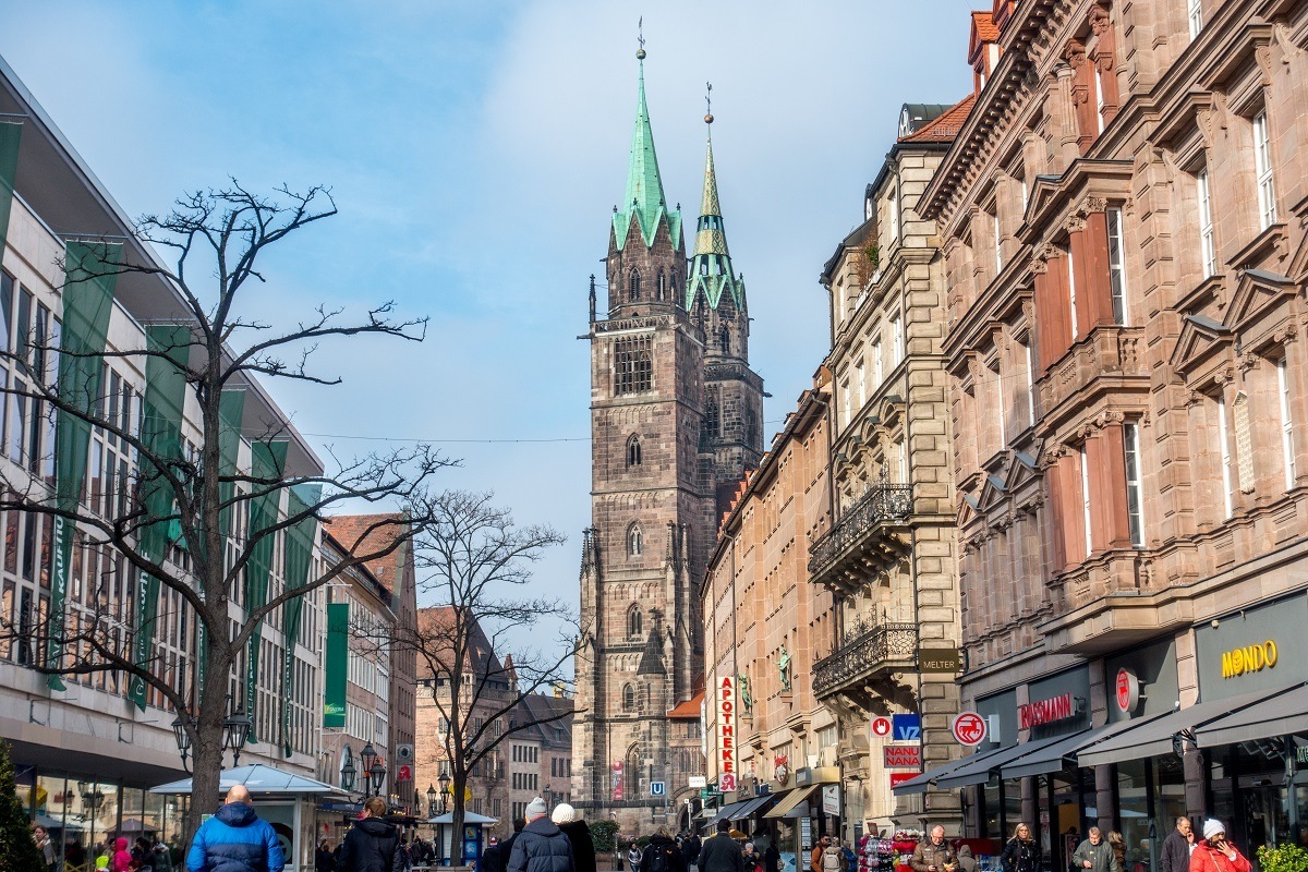 Street lined with stores and a church at the end, Konigstrasse