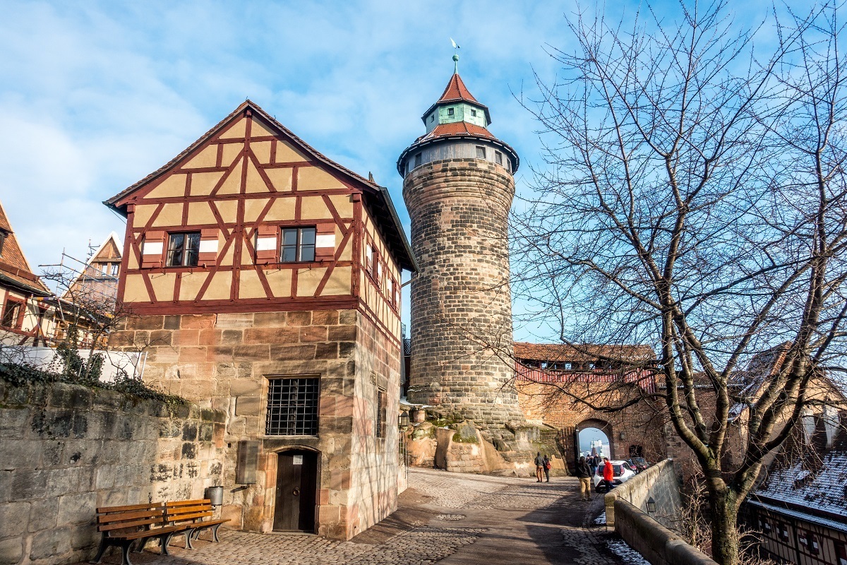 The round Sinwell Tower and the half-timbered Deep Well building are two parts of the Imperial Castle in Nuremberg that were not destroyed during World War II