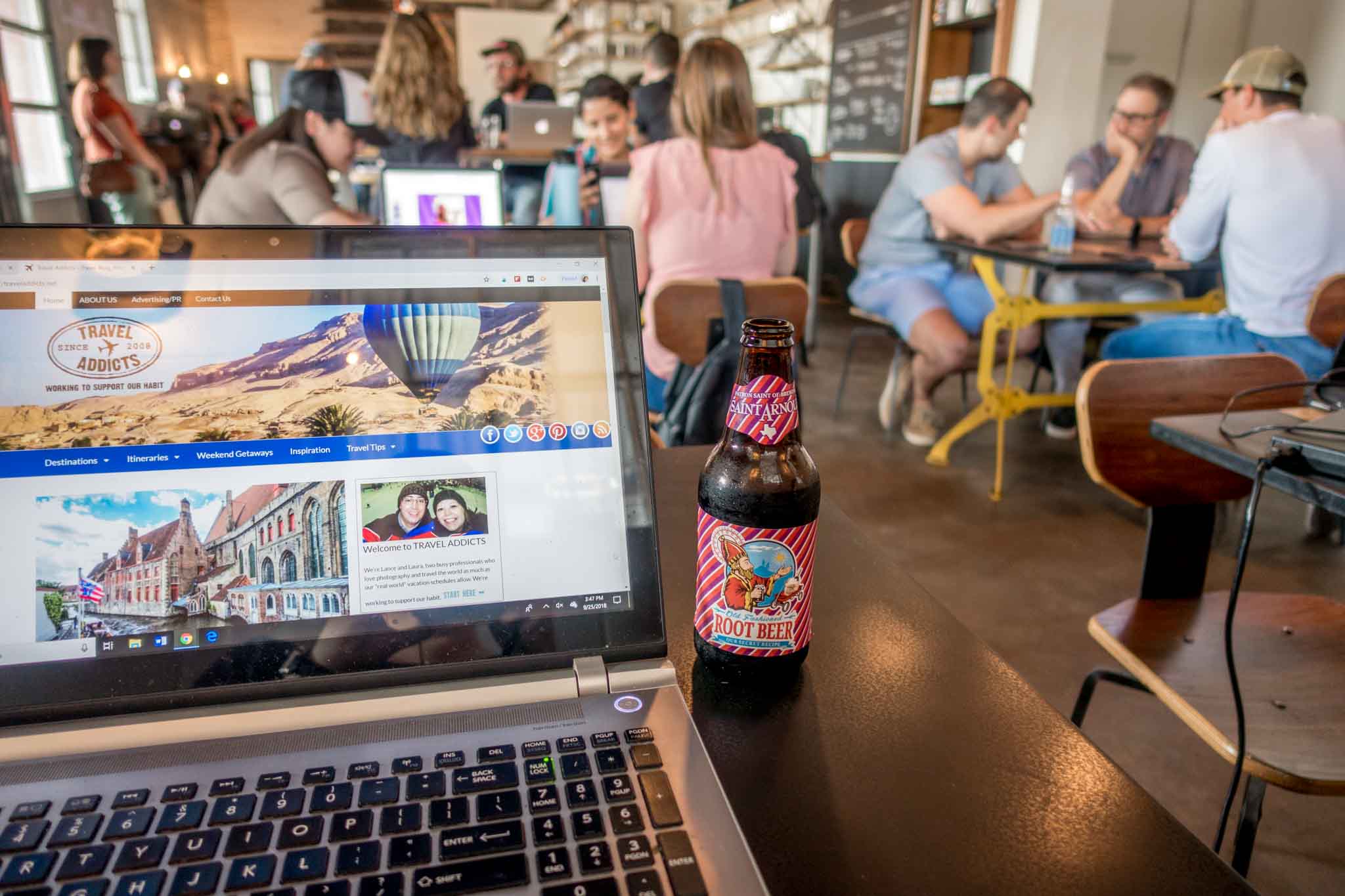 Computer and root beer on a table inside Wright Bros Brew and Brew in Texas