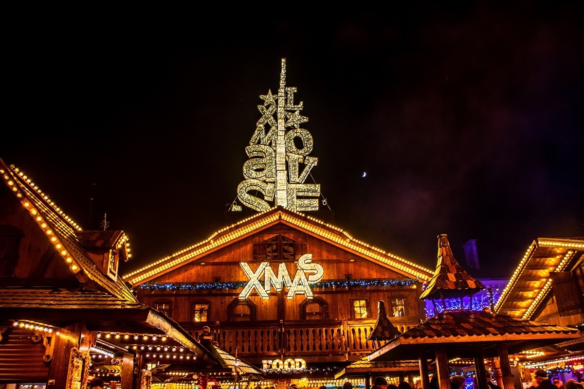 Food stall covered in Christmas lights spelling "love" and "Xmas" in Luxembourg