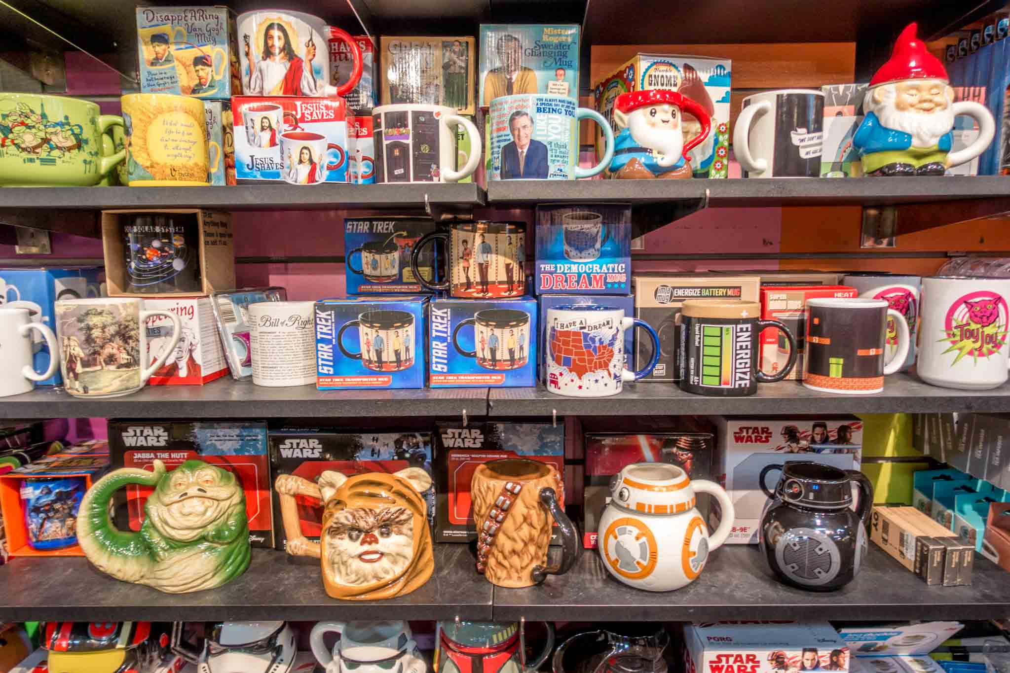 Star Wars-themed coffee mugs on a shelf at Toy Joy in Austin, Texas