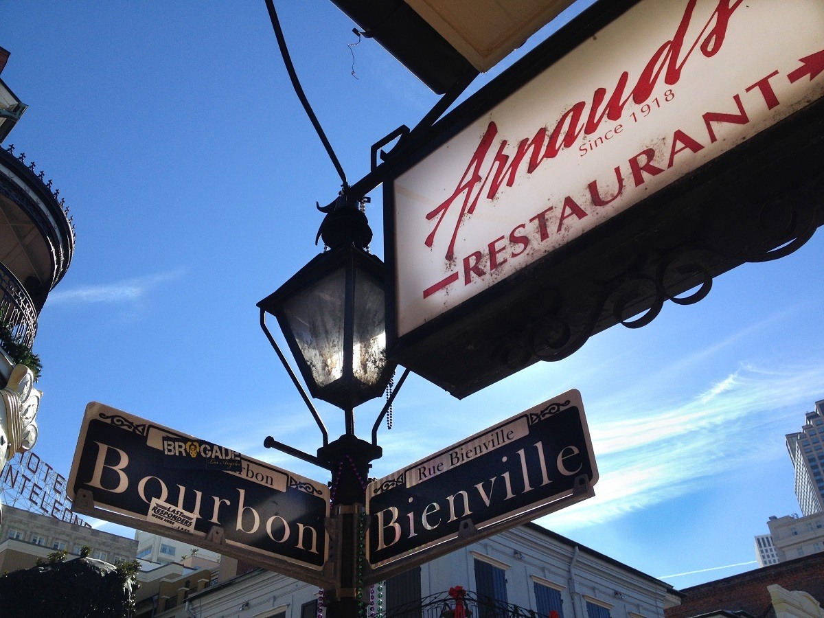 Sign for Arnaud's Restaurant next to street sign at the corner of Bourbon and Bienville
