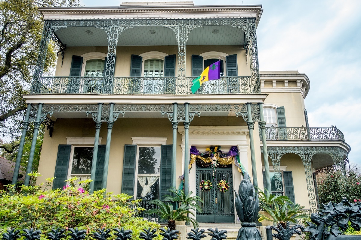 Yellow mansion with wrought iron balcony and fencing, Colonel Short's Villa in Garden District