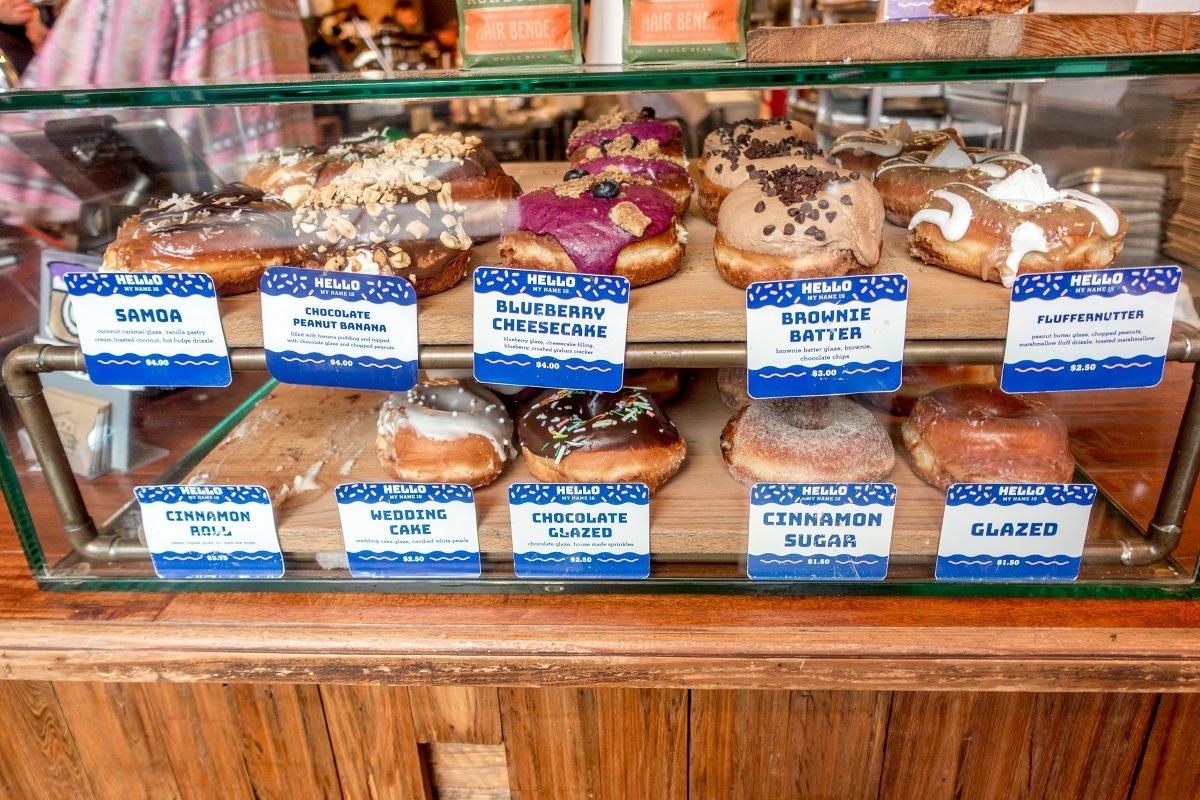 Unique flavors of donuts in display case at District Donuts