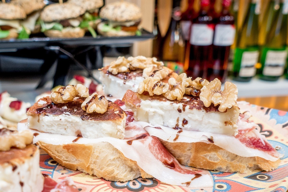 Goat cheese, jamon (ham), and walnuts on slices of bread in San Sebastian