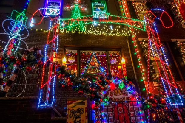 House lit up with numerous brightly colored lights as part of the Miracle on 13th Street, a display that is what to see in Philadelphia at Christmas