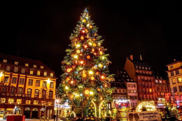 The Christmas tree in Place Kleber lit up at night. The tree is the symbol of the Strasbourg market, one of the best Christmas markets in Europe.