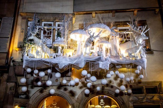Large Christmas display with reindeer and ornaments on a storefront in Carre d'Or in Strasbourg France