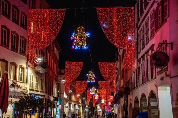 Gingerbread Christmas lights hanging across the streets of Strasbourg, one of the best Christmas markets in Europe