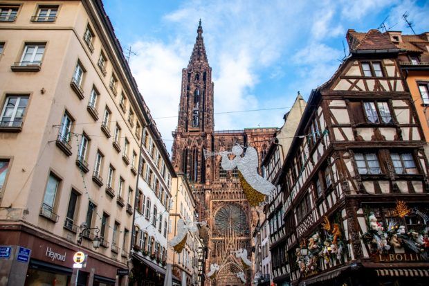 Christmas lights in the shape of angles hang in front of the Strasbourg Cathedral