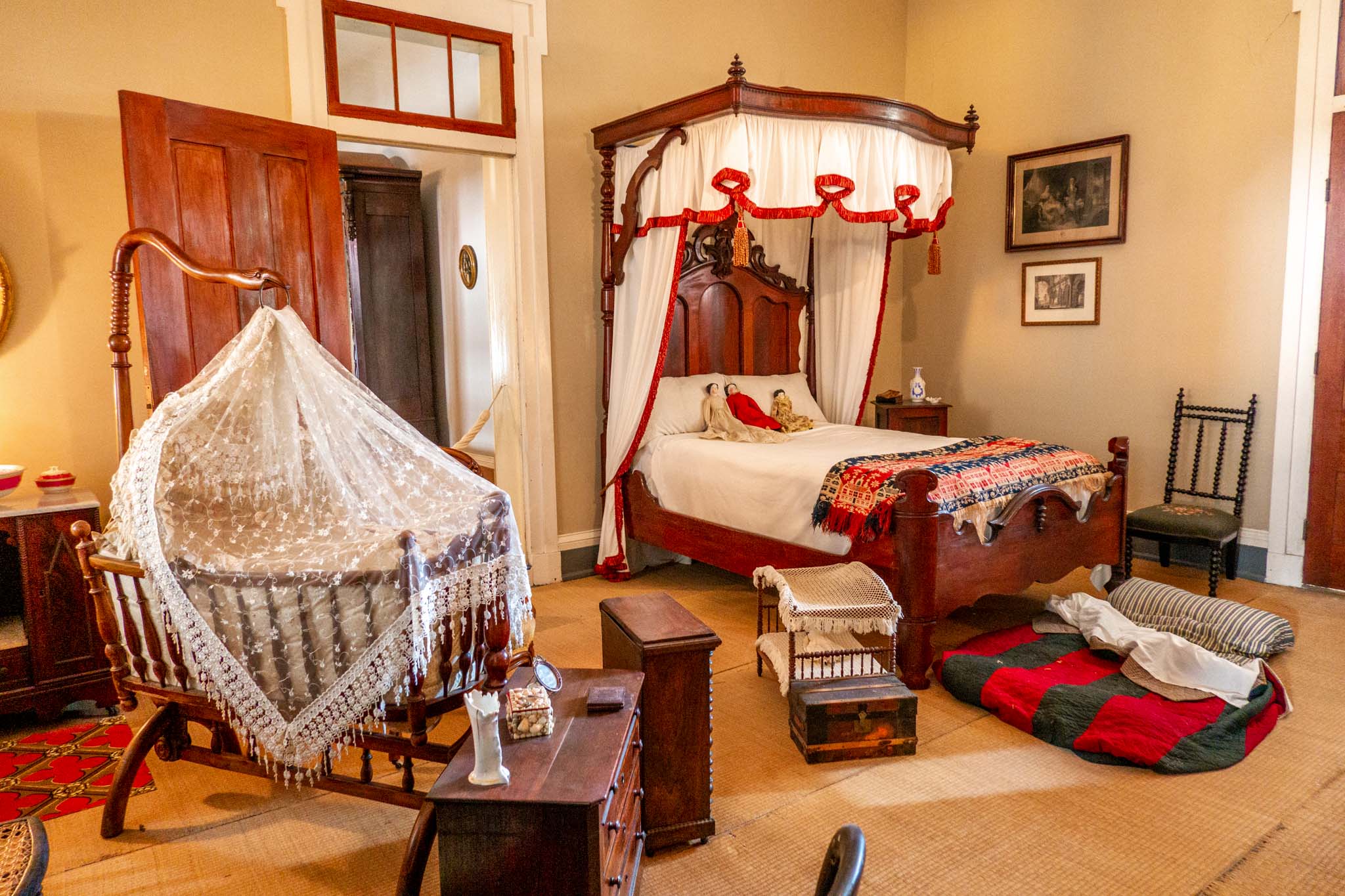 Bed and crib in children's bedroom with slave bed on the floor
