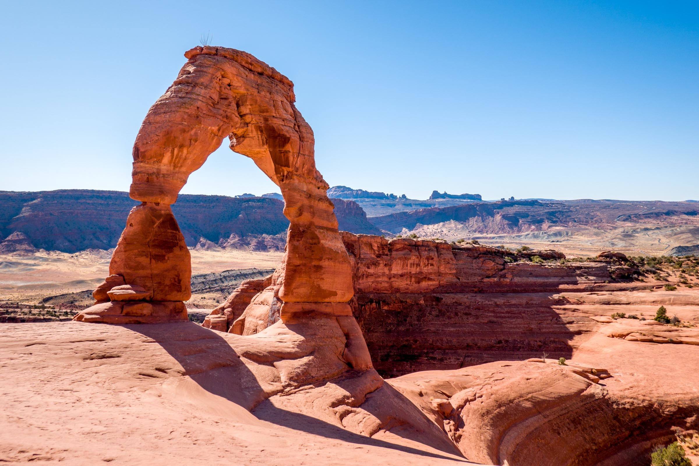 Large orange rock arch -- Delicate Arch in Arches National Park at mid-day