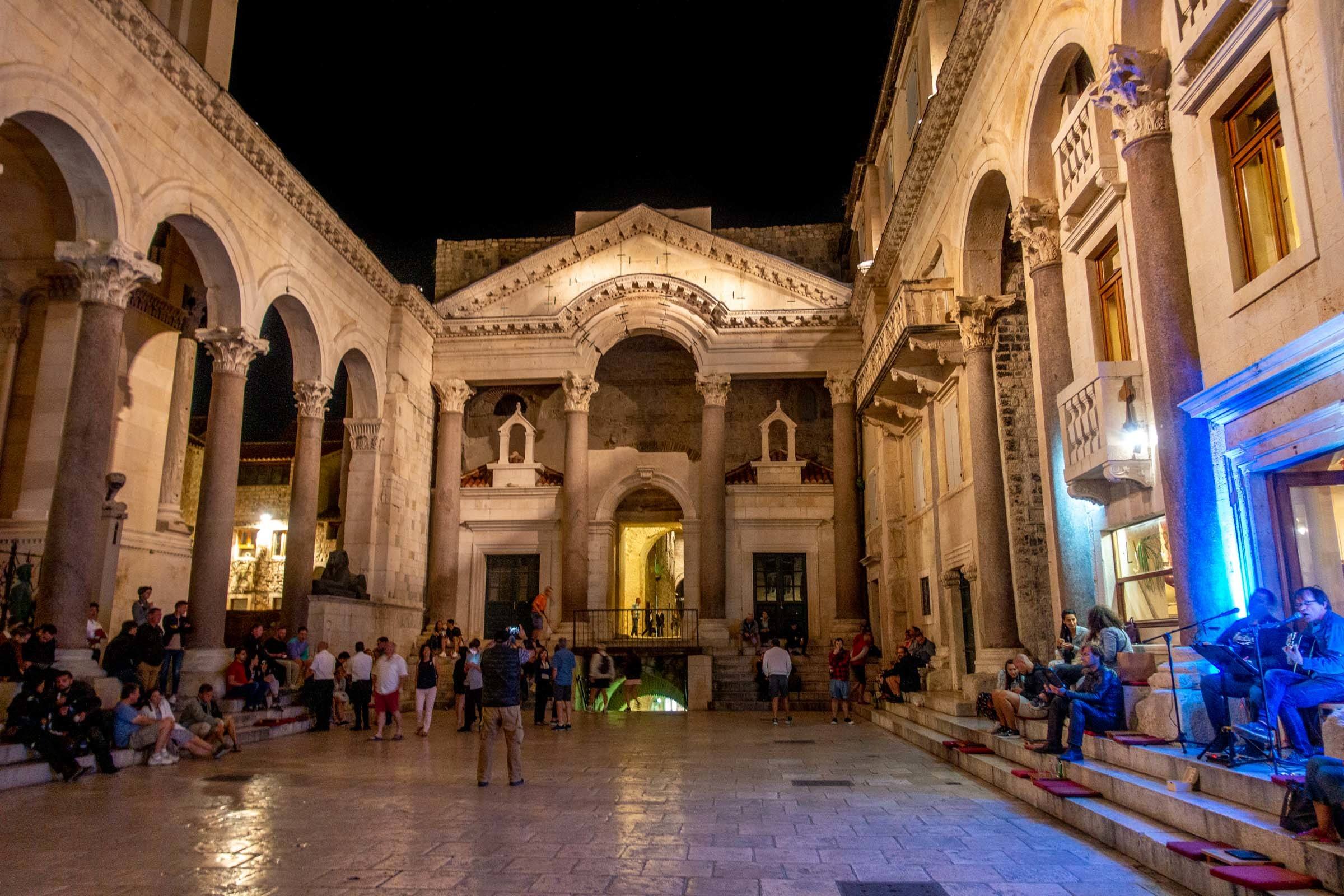 Marble peristyle (courtyard) of 4th-century Diocletian's Palace in Split, Croatia filled with people at night